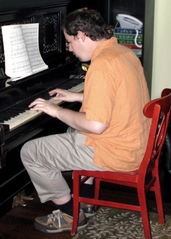 Academy House resident playing piano
